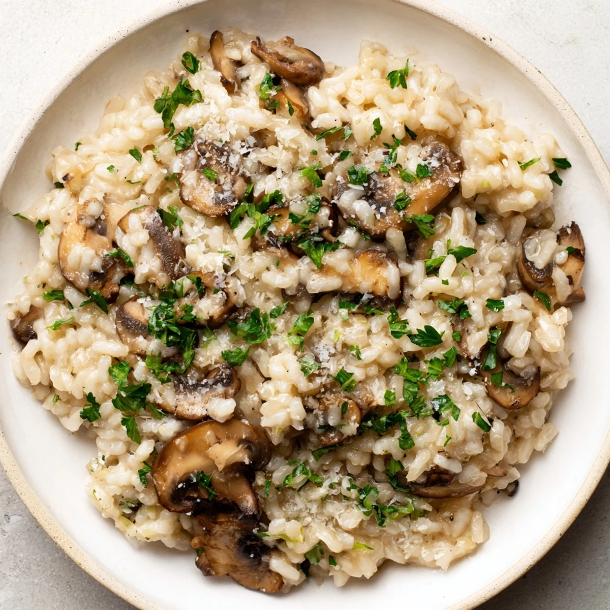 Steaming, rich Stove-Top Creamy Risotto, a comforting Italian dinner, is plated and ready to eat.
