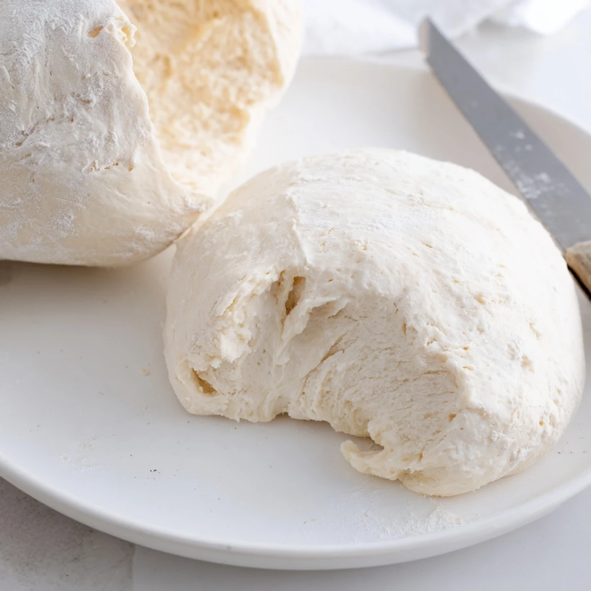 Golden, bubbly Homemade Pizza Dough ready for toppings, promising a delicious, family-style pizza.