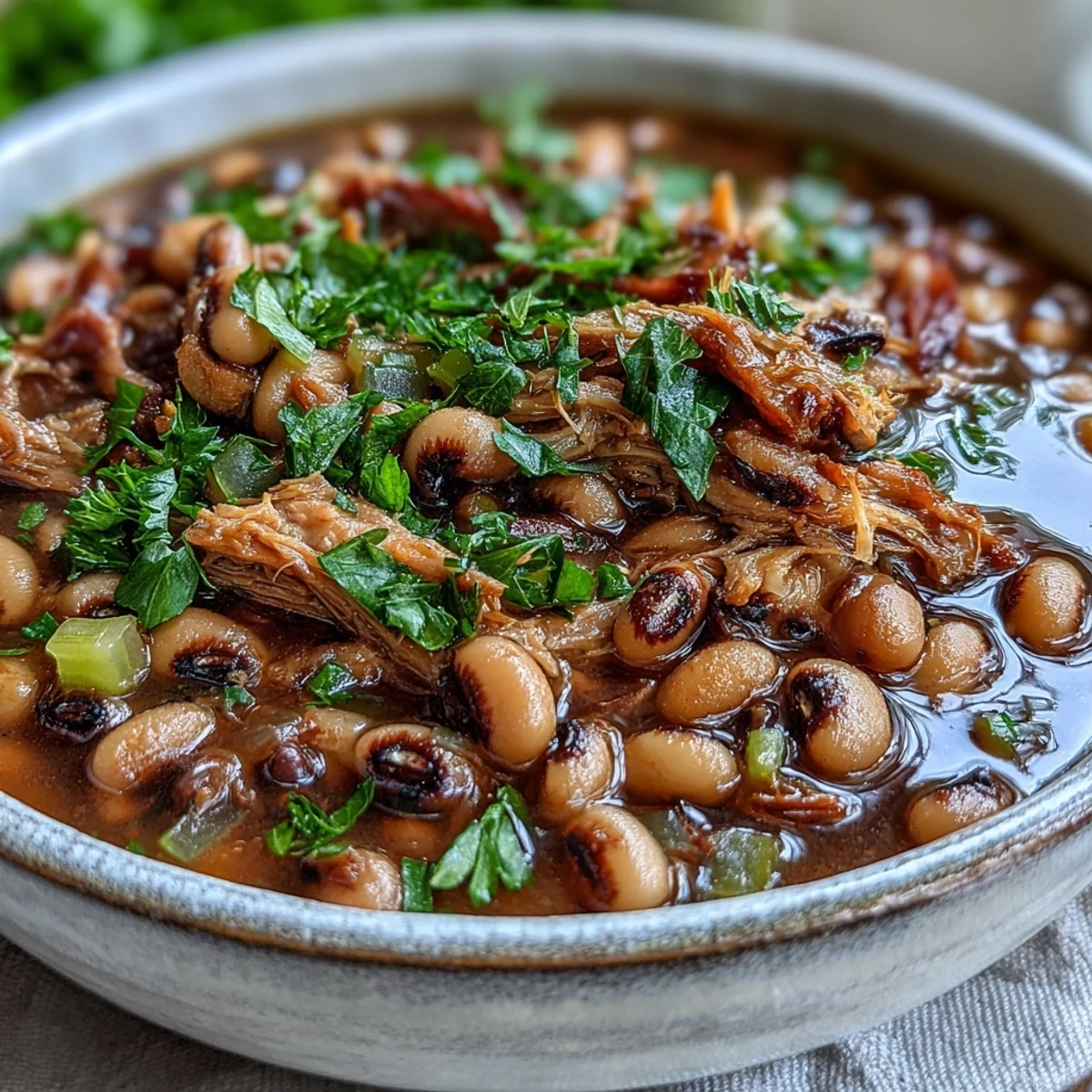 Southern-style Classic New Years Black-Eyed Peas topped with hot sauce, served alongside golden cornbread for a traditional New Year's meal.