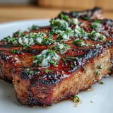 Tender lamb chops topped with zesty lemon-garlic gremolata, offering a fresh and aromatic twist to classic Italian cooking.  