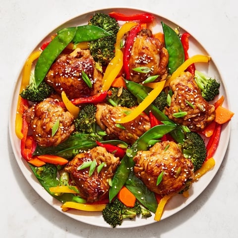 Sheet Pan Chicken Stir-Fry with glistening vegetables, perfect for a quick and flavorful dinner.