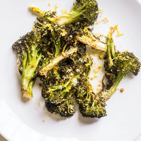 Lemon Garlic Roasted Broccoli is golden-brown on a pan, smelling delicious with garlic and lemon.