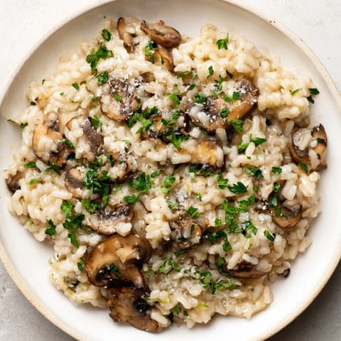Steaming, rich Stove-Top Creamy Risotto, a comforting Italian dinner, is plated and ready to eat.