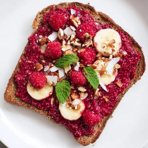 Homemade raspberry chia jam toast, perfect for a quick, healthy snack with fresh berries.