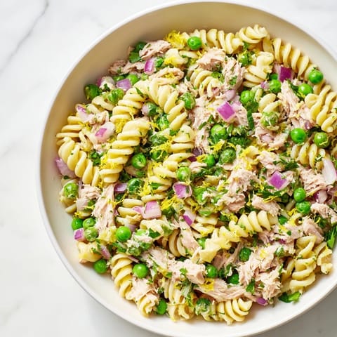 Close-up of Lemony Tuna Pasta Salad showing al dente pasta tossed with lemon zest, dill, and olive oil.  