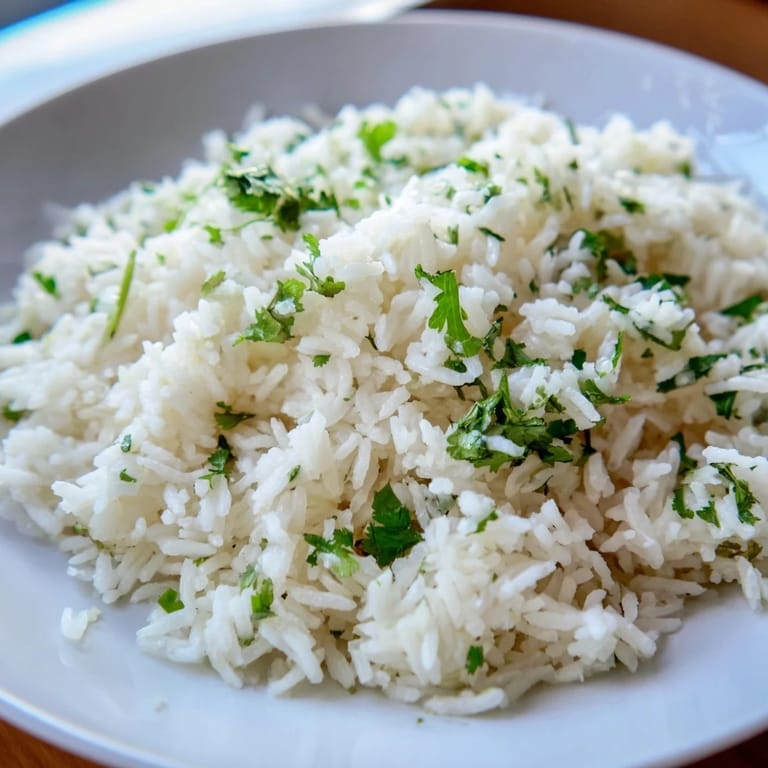 A bowl of bright Cilantro Lime Rice, ready to be served, imagining the fresh flavors in every bite.