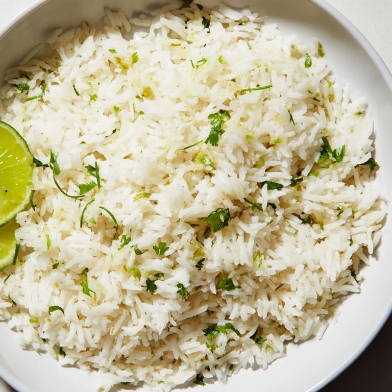 Steaming plate of Cilantro Lime Rice, highlighting the perfect texture, a delicious side dish for tacos.