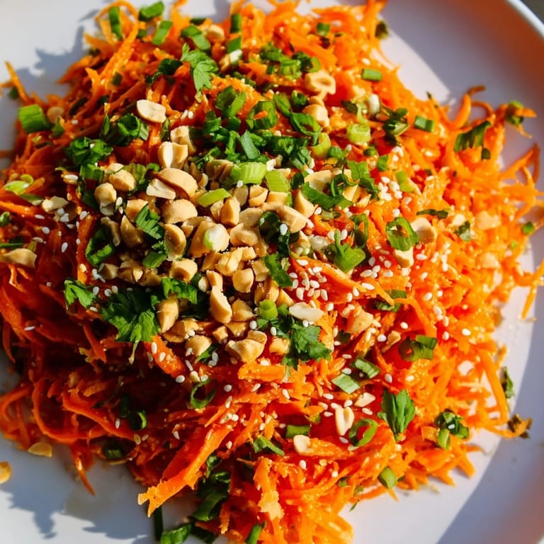 Close-up of a colorful Spicy Carrot Salad, perfect side dish with peanuts and sesame, ready to serve.
