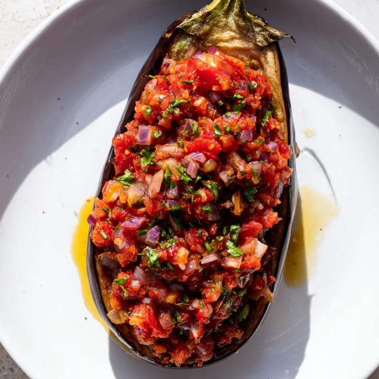 A close-up of Imam Bayildi: slow-baked eggplant filled with a delicious, rich vegetable medley.