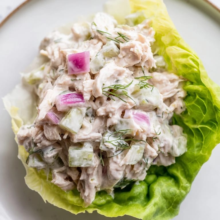 Platter of dill pickle chicken salad lettuce cups, each cup overflowing with creamy, crunchy chicken salad goodness.