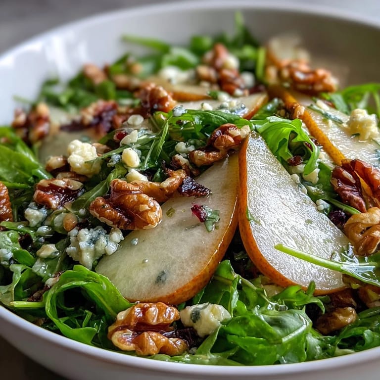 Arugula and Pear Bowl served as a refreshing light lunch garnished with honey drizzle and fresh herbs.